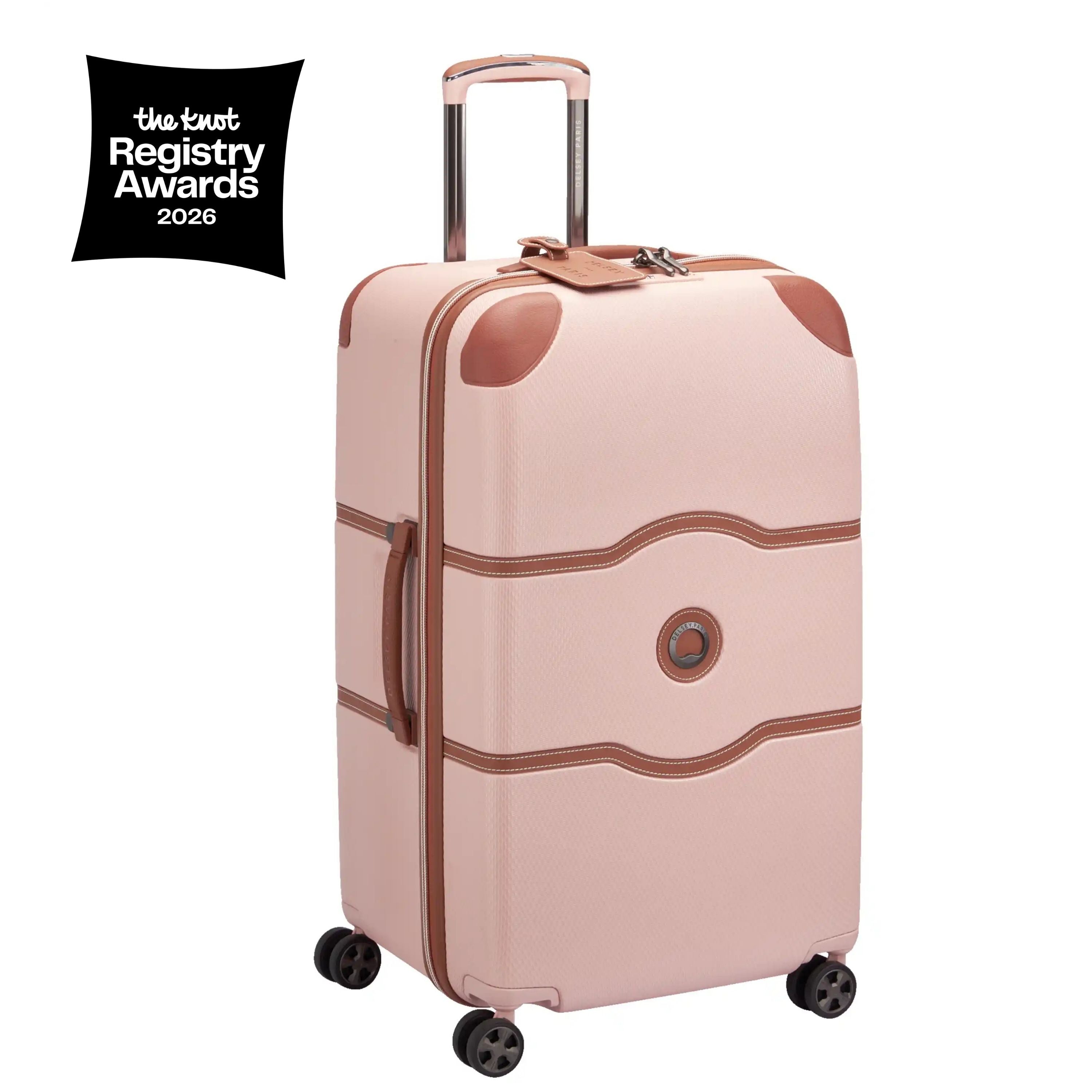 Pink suitcase with brown accents on a white background, featuring the Knot Registry Awards logo.